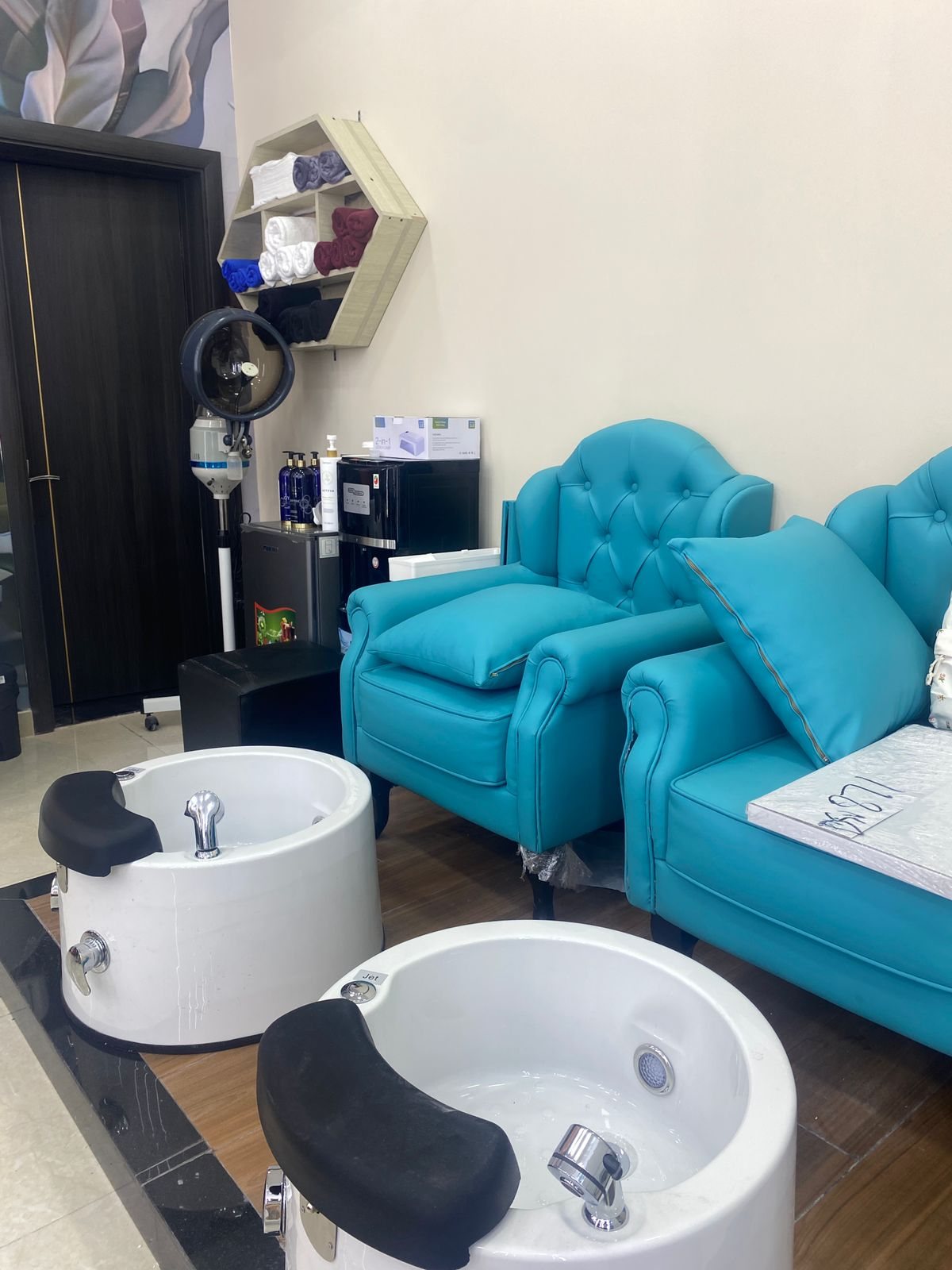 Pedicure lounge with teal chairs at Cindy Glow Beauty Salon Dubai